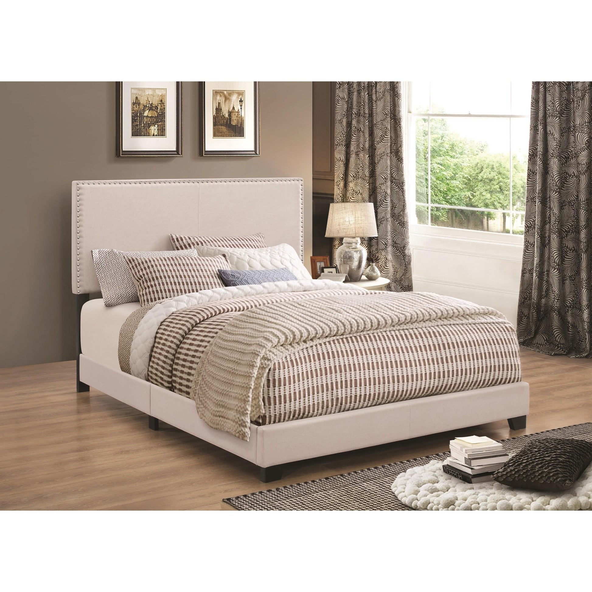 Cal King upholstered bed in ivory with nailhead trim in a stylish bedroom by Benzara.