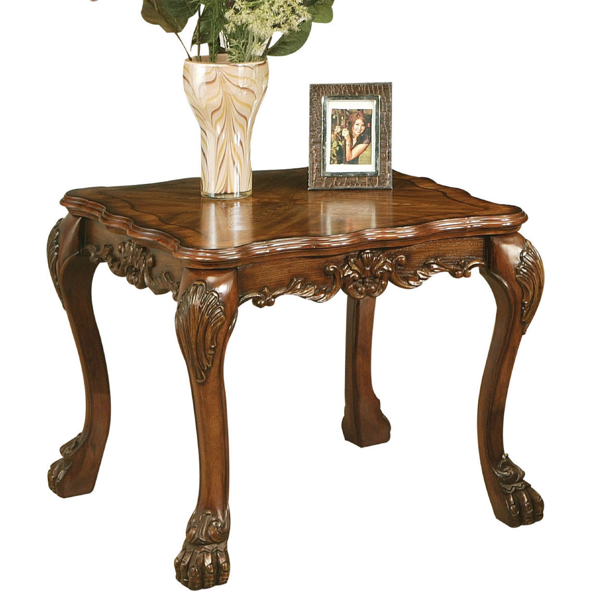 Wooden end table in traditional style, cherry oak brown finish with ornate carved legs