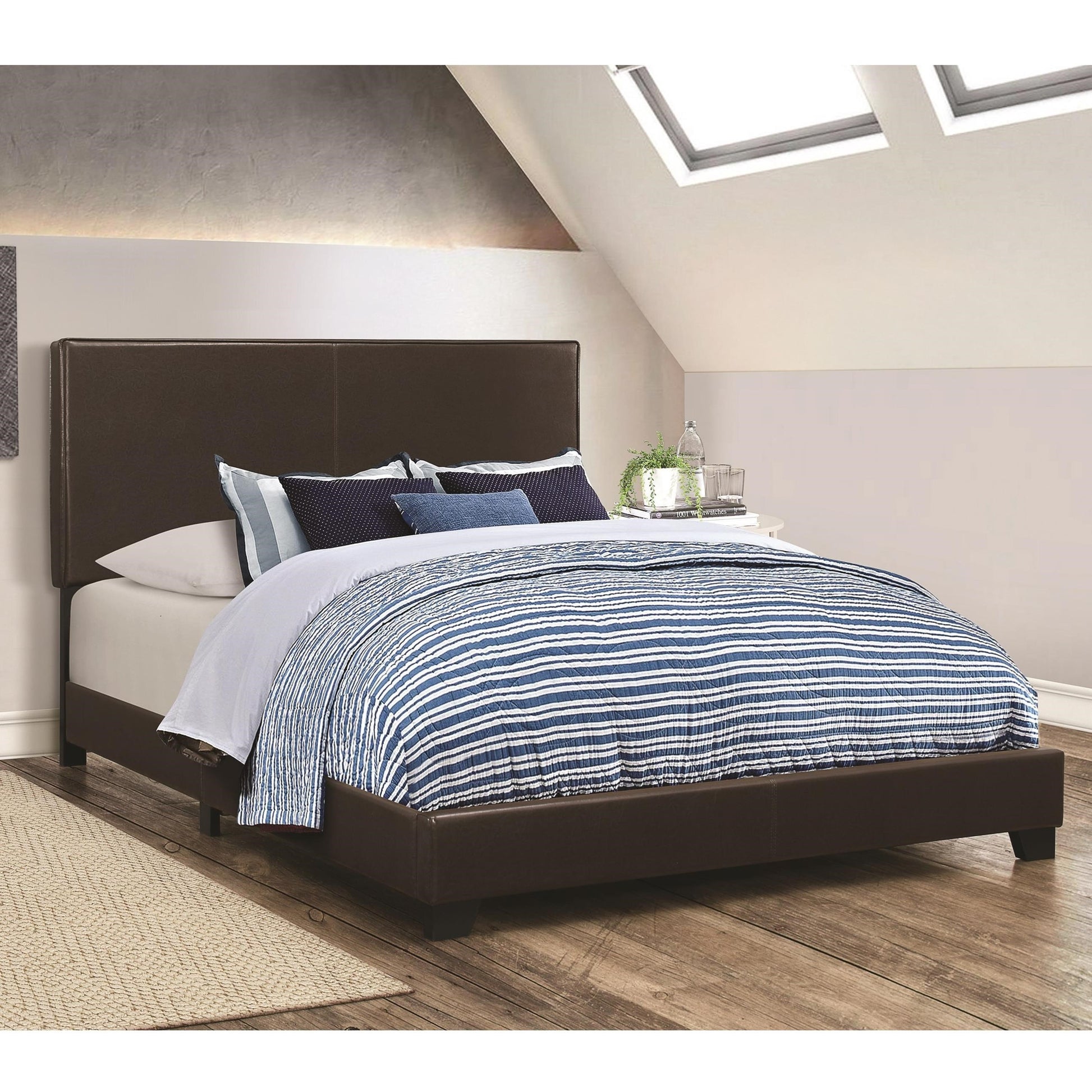 Leather upholstered California King platform bed in brown with a padded headboard.