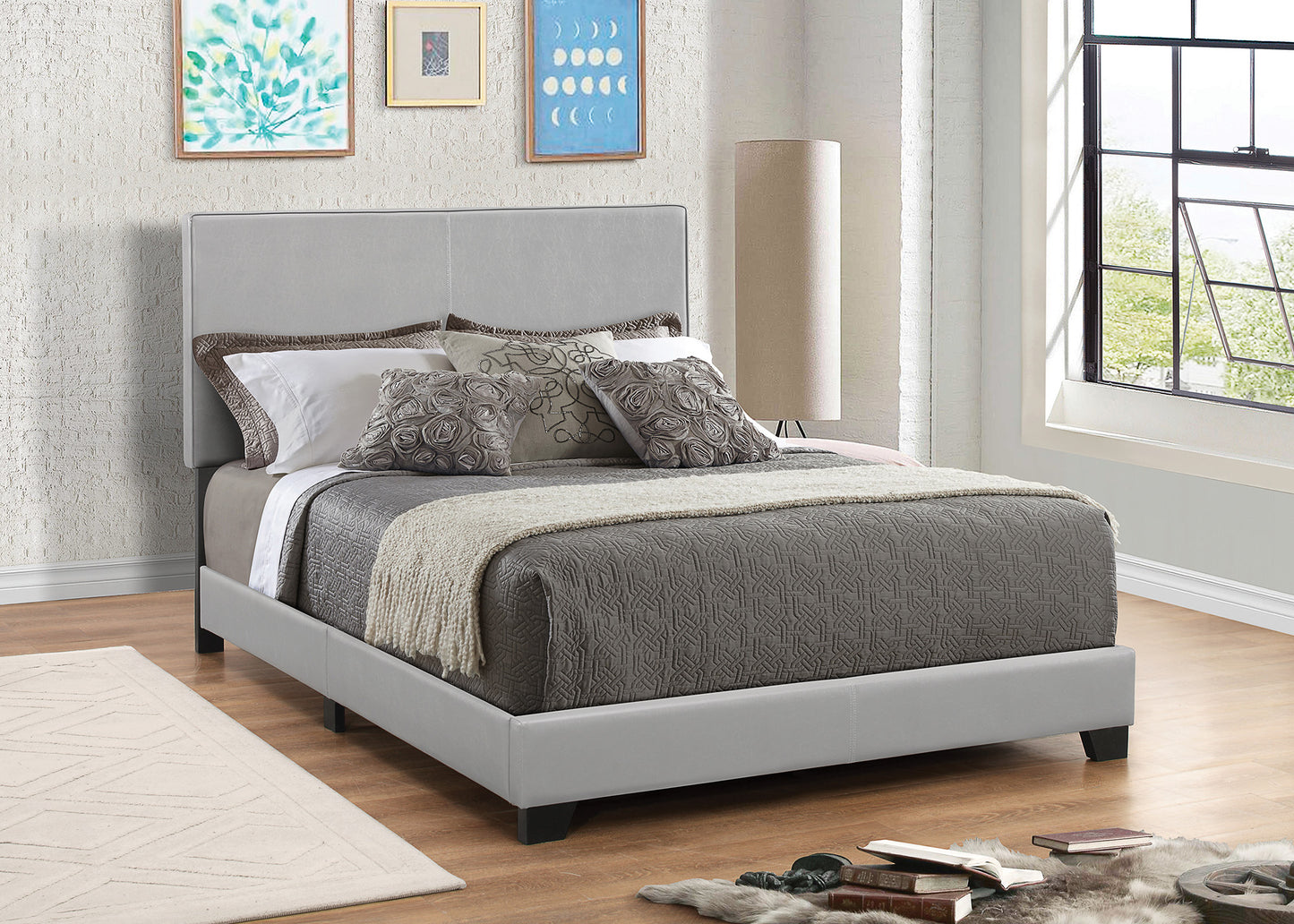 Leather upholstered queen-size platform bed in gray with a modern headboard