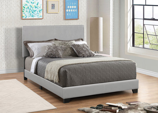 Leather upholstered queen-size platform bed in gray with a modern headboard
