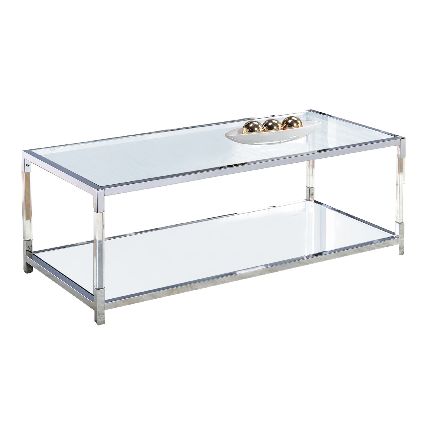 Glass-top metal coffee table with open bottom shelf; silver frame and clear glass, with a white dish and three gold spheres