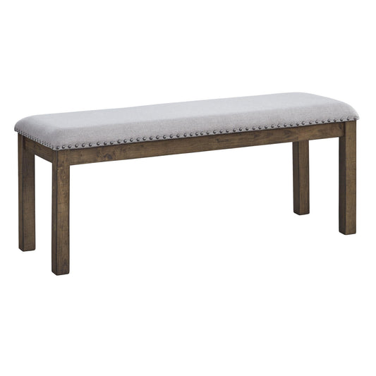 Wooden dining bench with gray fabric upholstery and nailhead trim; brown-stained legs.