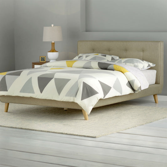 Queen size mid-century beige upholstered platform bed with tufted headboard and light wood legs.