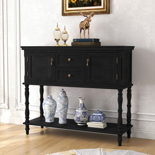 Retro black wooden console table with 2 drawers and 2 cabinets, gold hardware, lower shelf with blue-and-white vases.