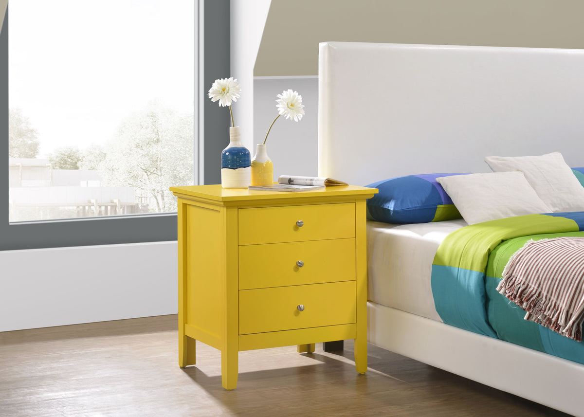 Yellow-painted nightstand with three drawers, topped by two vases and white flowers.
