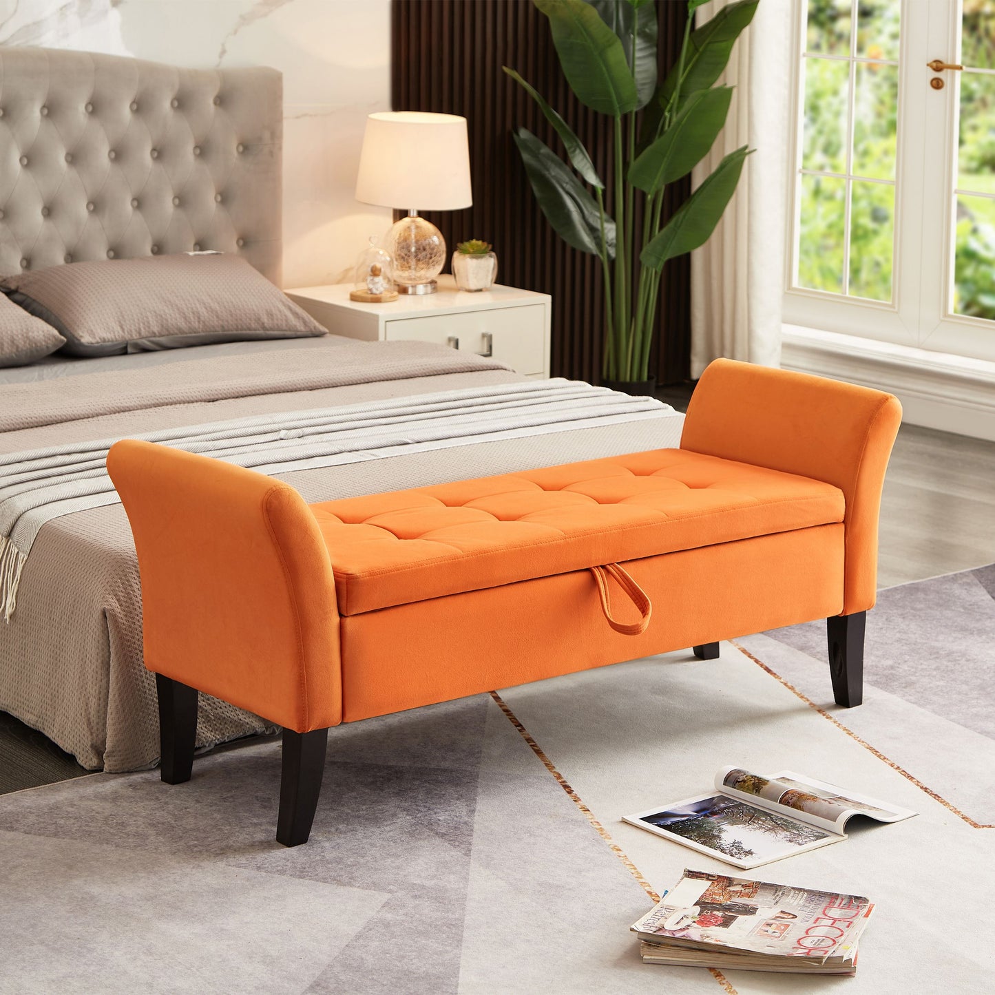 Orange velvet bed bench with storage at foot of gray upholstered bed in a modern bedroom