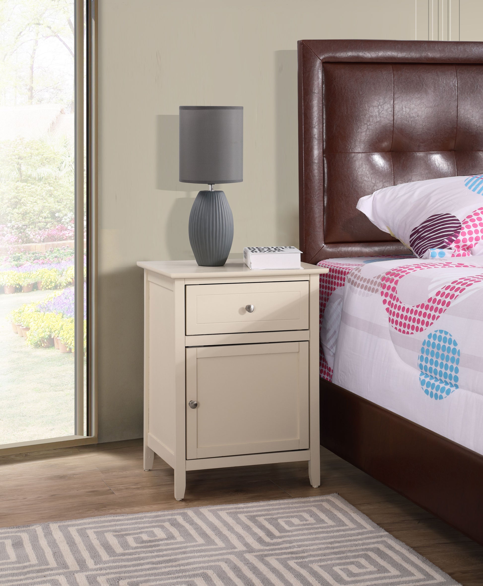 Charming beige transitional nightstand with a top drawer and lower cabinet beside bed