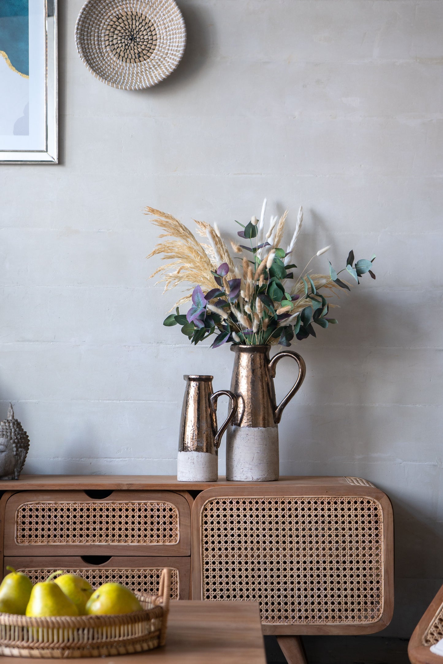 Candia Terracotta Pitcher pair in sienna brown by Doba on a wooden console with dried bouquet