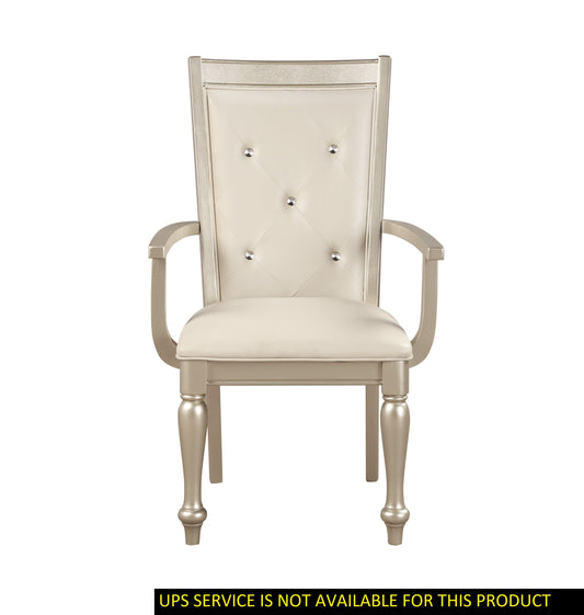 Arm chair with a modern silver finish frame, cream tufted upholstery and crystal button accents