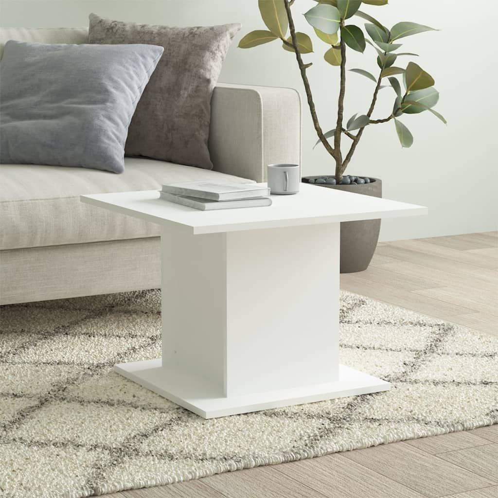 Coffee table white engineered wood with square pedestal base in a modern living room.