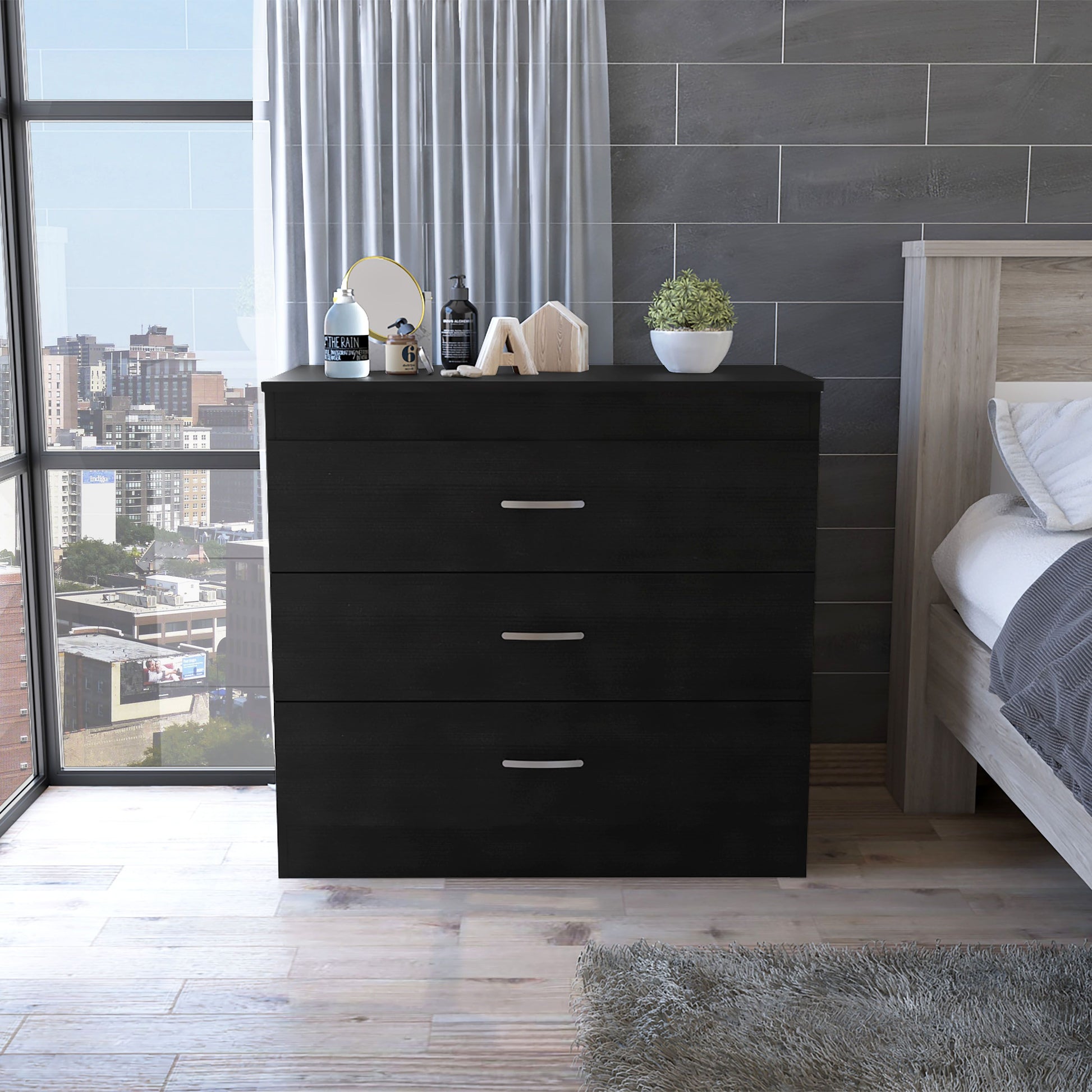 Bethage 3-Drawer Dresser in black wengue finish with silver handles in a modern bedroom