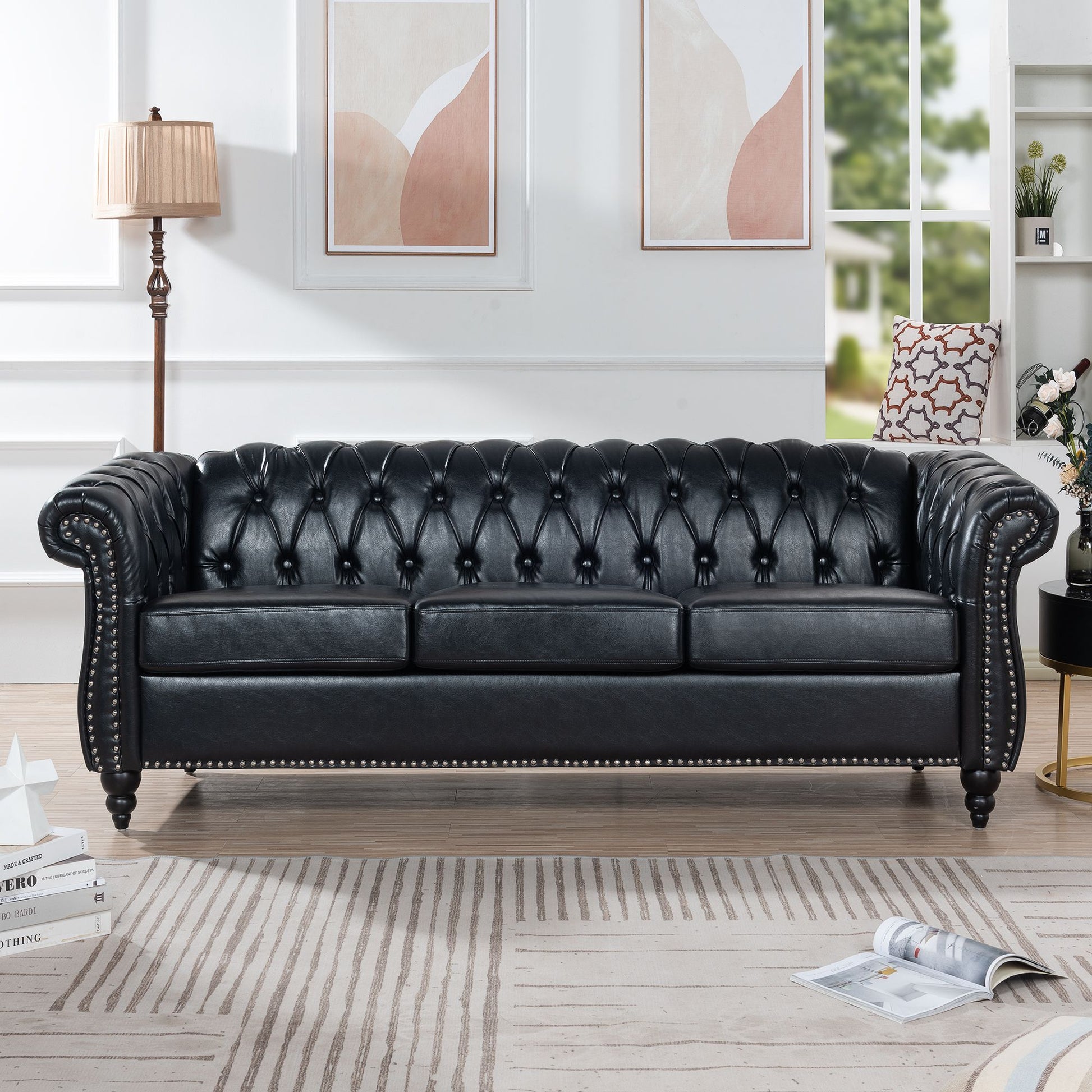 Chesterfield-style black PU leather three-seater sofa with rolled arms and tufted back