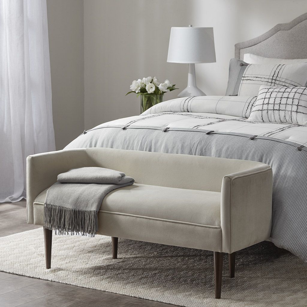 Farrah Accent Bench by Doba in beige upholstery with dark wood legs at bed foot