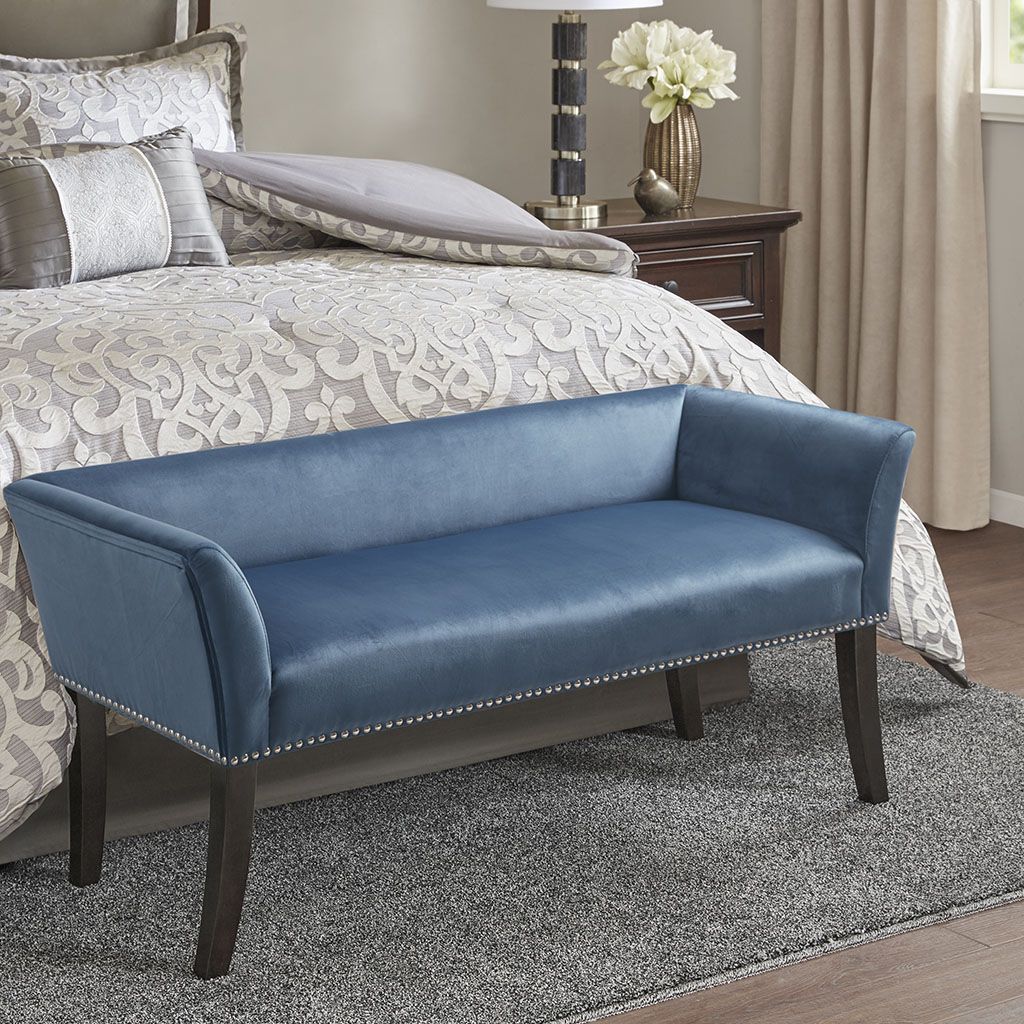 Accent bench in blue faux-leather upholstery with nailhead trim and dark wood legs.