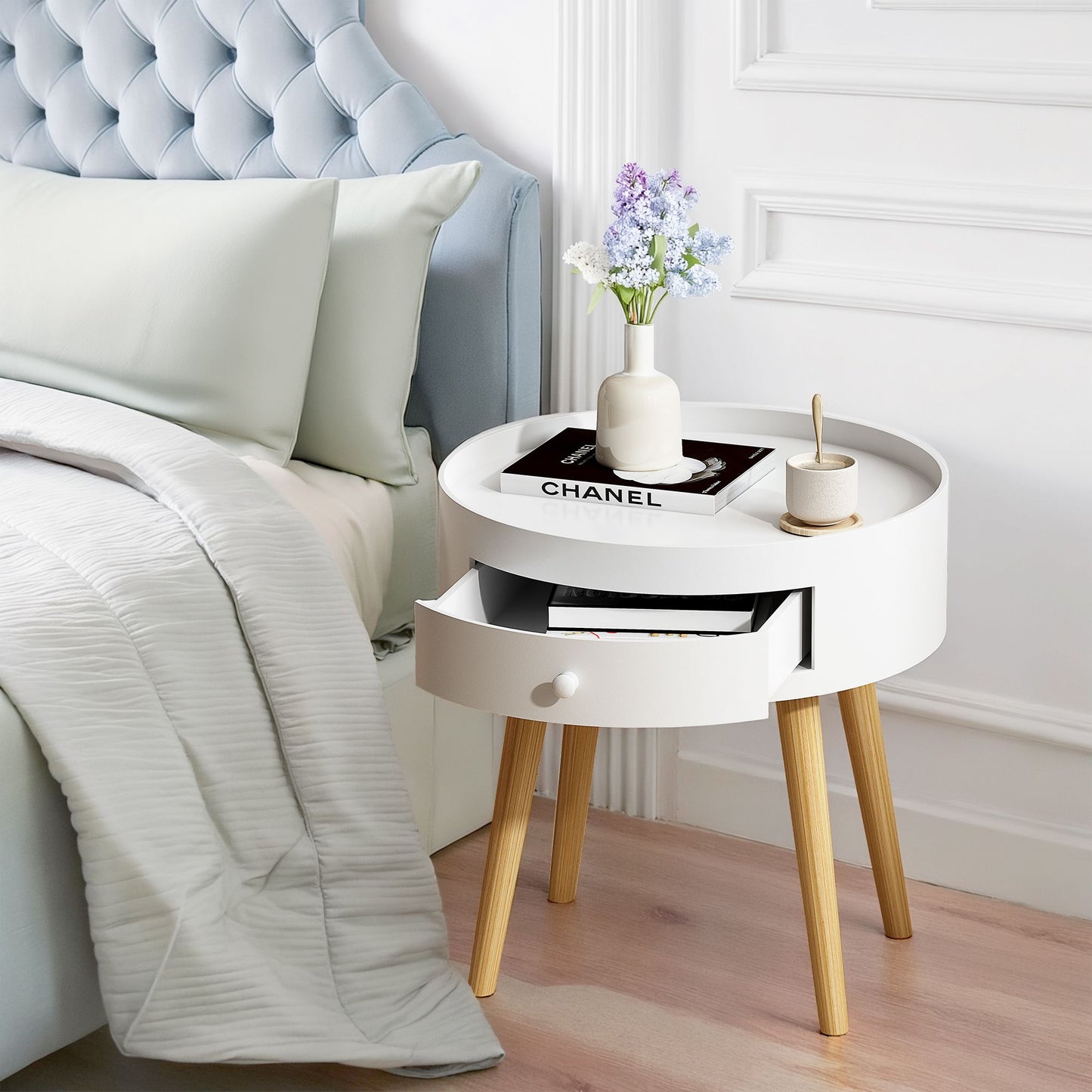 18-inch white round nightstand with storage drawer and oak legs, Chanel magazine on top
