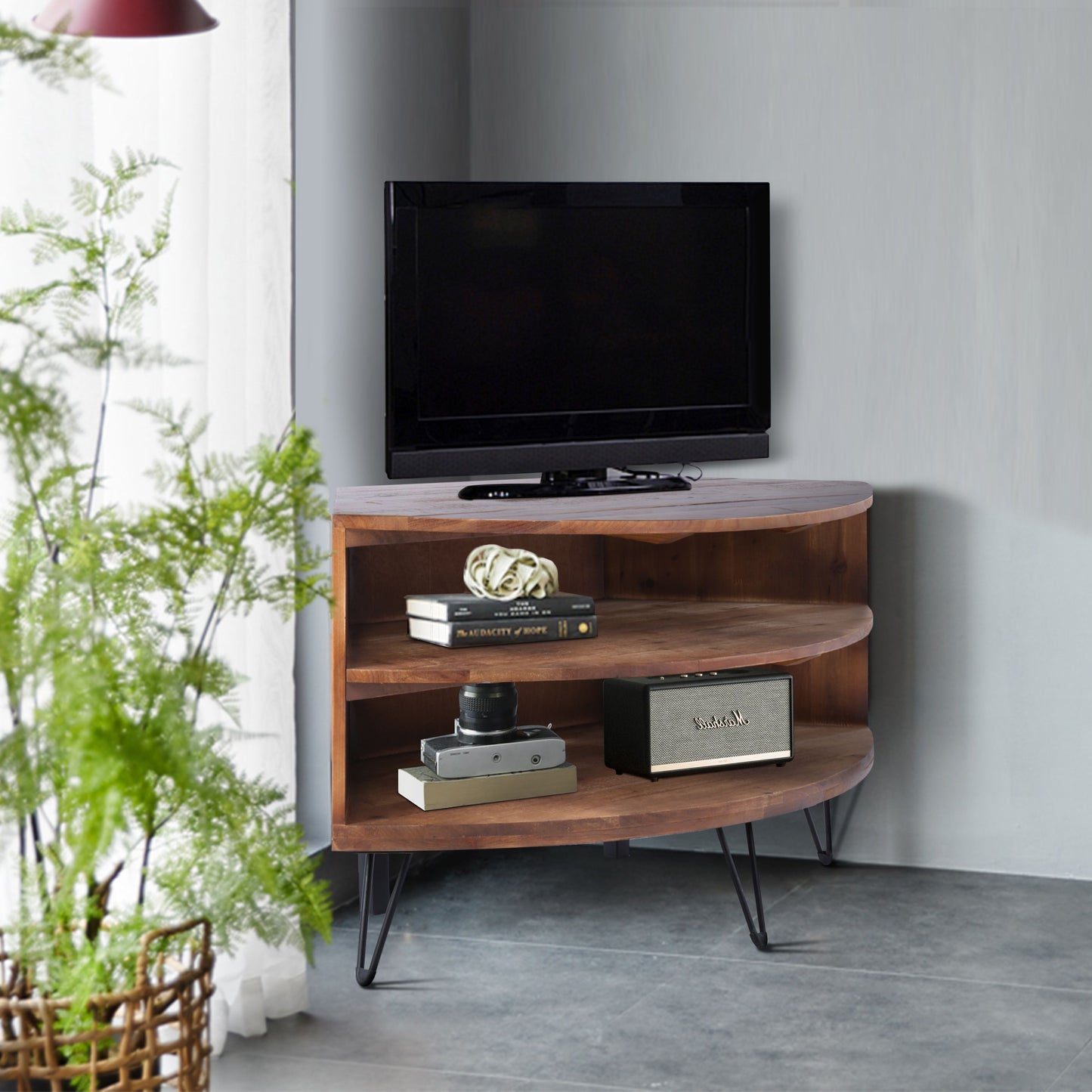 Fan-shaped reclaimed wood corner media table with TV on top and Marshall speaker on lower shelf, by Doba.