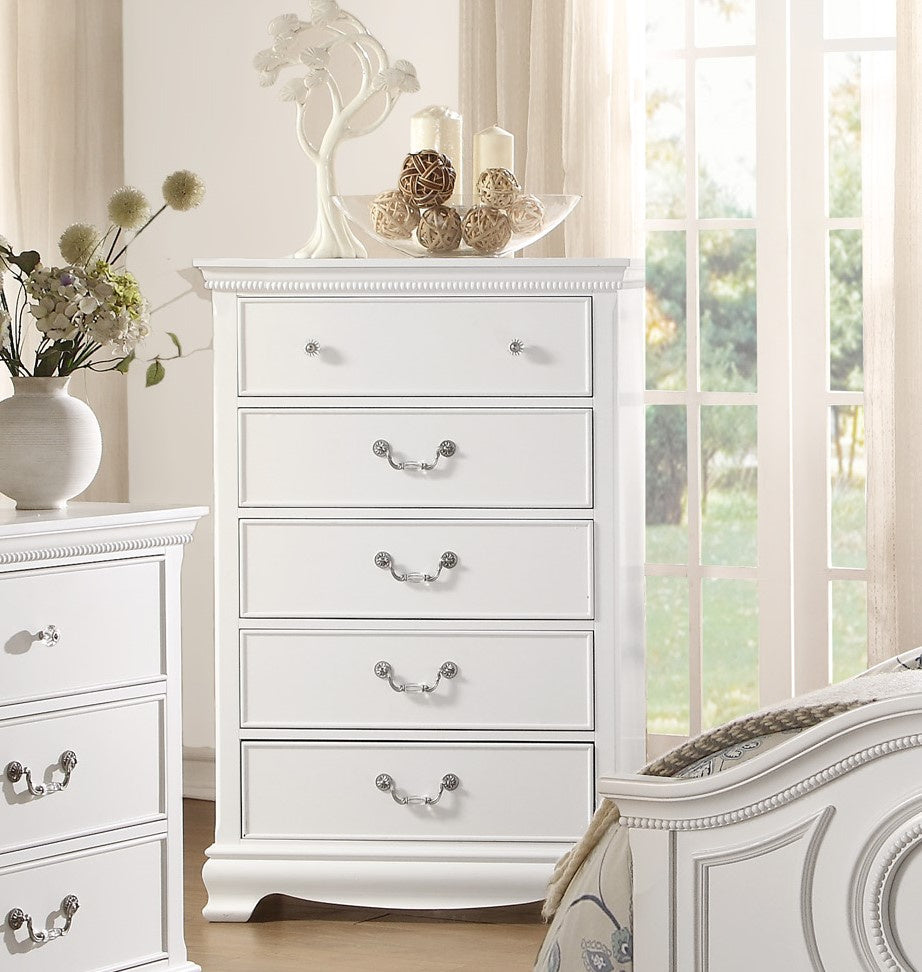 Two white traditional chests of drawers with ornate silver handles in a bright bedroom
