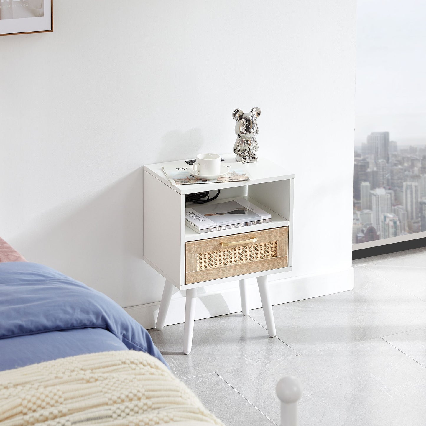 White end table with cane-front drawer and solid wood legs, topped by a metallic bear figurine.