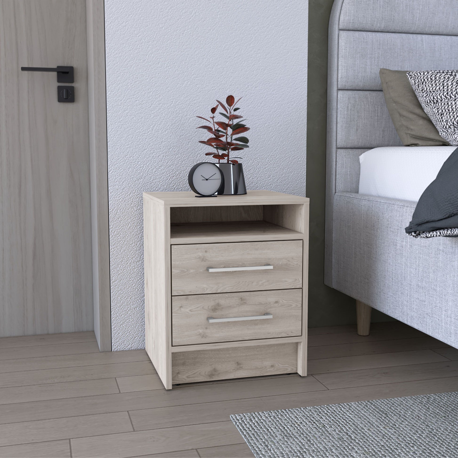 Eter nightstand with two drawers and open shelf in light wood finish, shown beside a gray upholstered bed