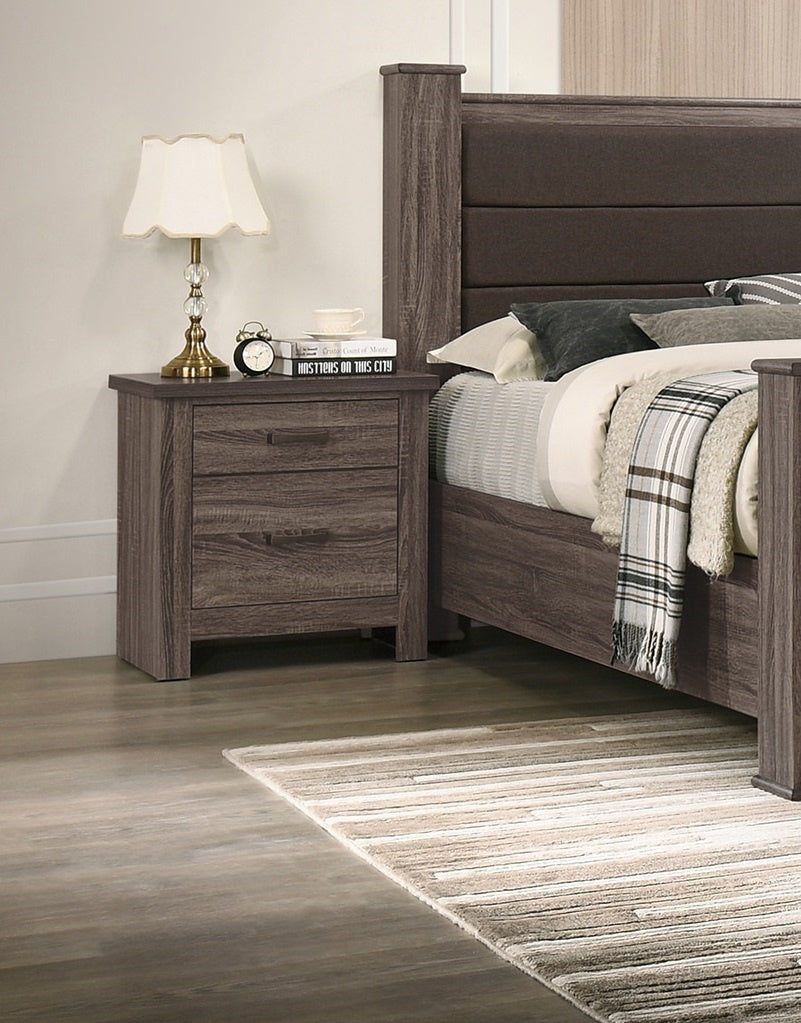 Doba wooden nightstand with two drawers in a dark natural wood finish beside a bed