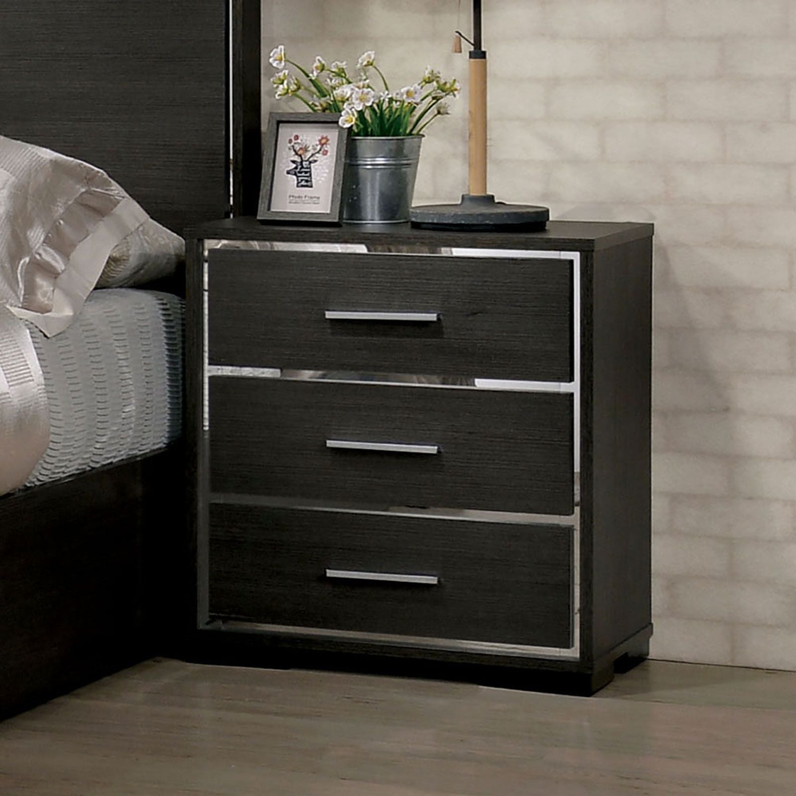 Nightstand in dark wood with chrome-trim framed three-drawer design for a modern contemporary bedroom