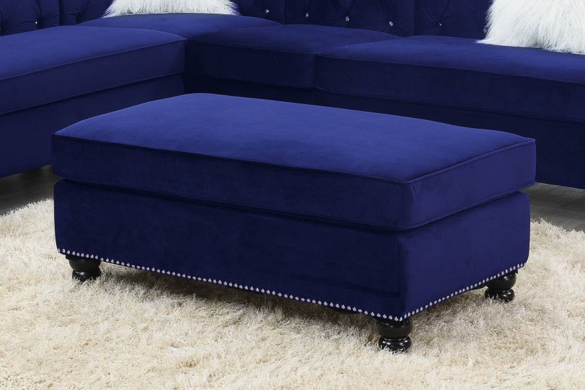 Indigo blue velvet cocktail ottoman with studded trim and wooden legs