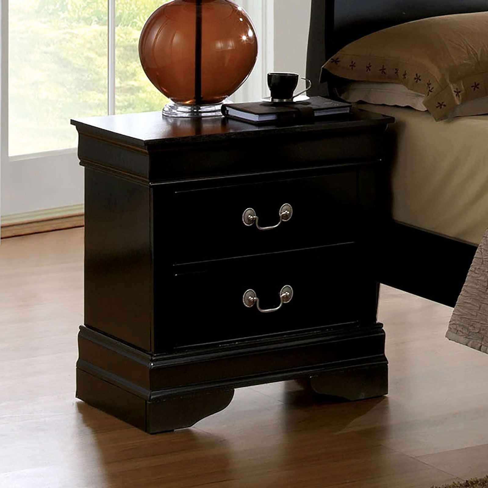Black solid-wood Louis Philippe nightstand with dovetail drawers and antique nickel pulls, shown with lamp.