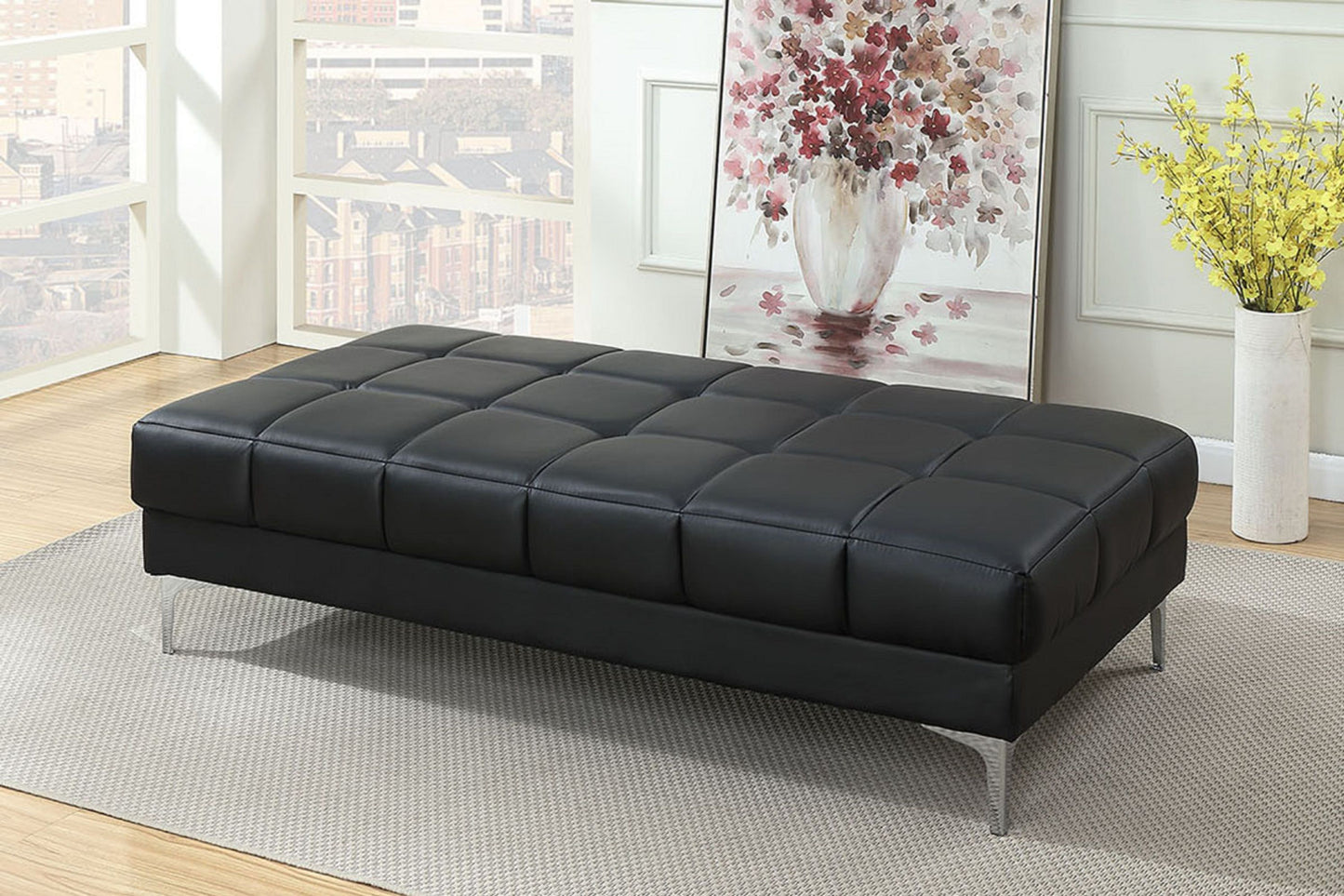 Ottoman, black bonded-leather, extra large with metal legs in living room.