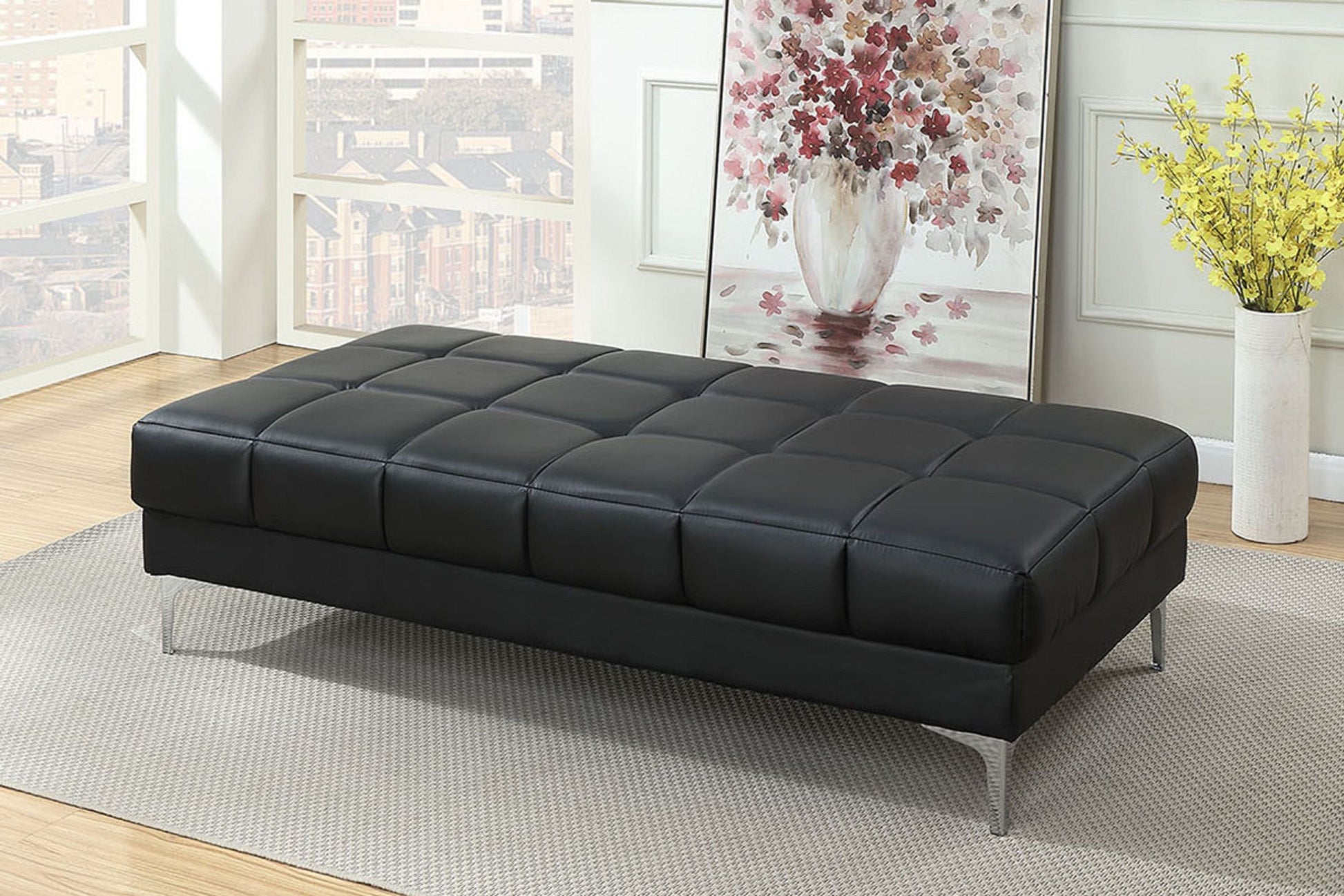 Ottoman, black bonded-leather, extra large with metal legs in living room.