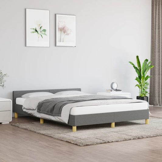 Bed frame with headboard in dark gray upholstery and light wood legs.