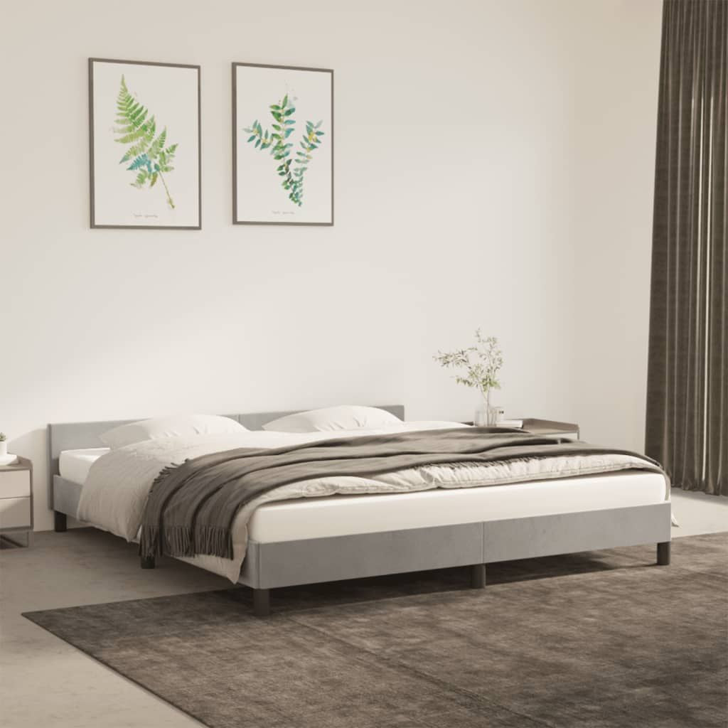 Bed frame with upholstered headboard in light grey velvet; engineered wood and plywood construction; Doba brand.