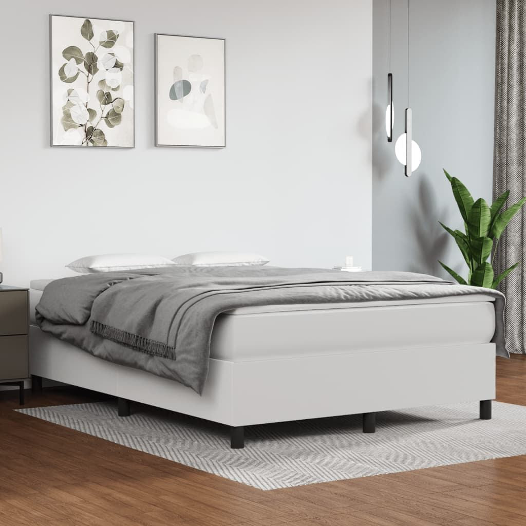 White bed frame with grey duvet in a minimalist modern bedroom