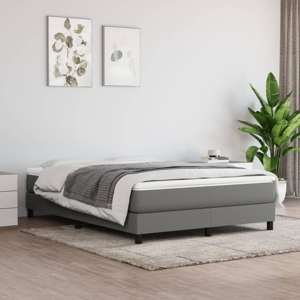 Full-size bed frame in dark grey polyester upholstery with plywood and engineered wood base.