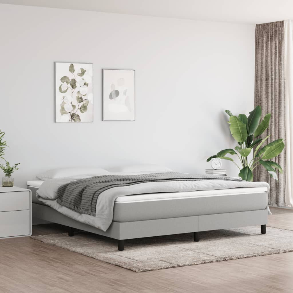 Box Spring Bed Frame in light gray fabric, king size, modern bedroom with plants and wall art