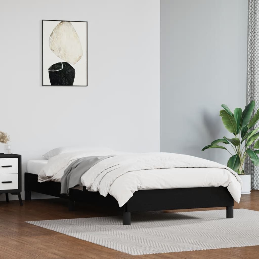 Twin bed frame, black faux leather upholstery with plywood and engineered wood platform.