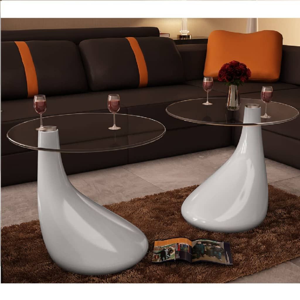 Coffee table set of 2 with round glass tops and glossy white fiberglass bases in a contemporary living room