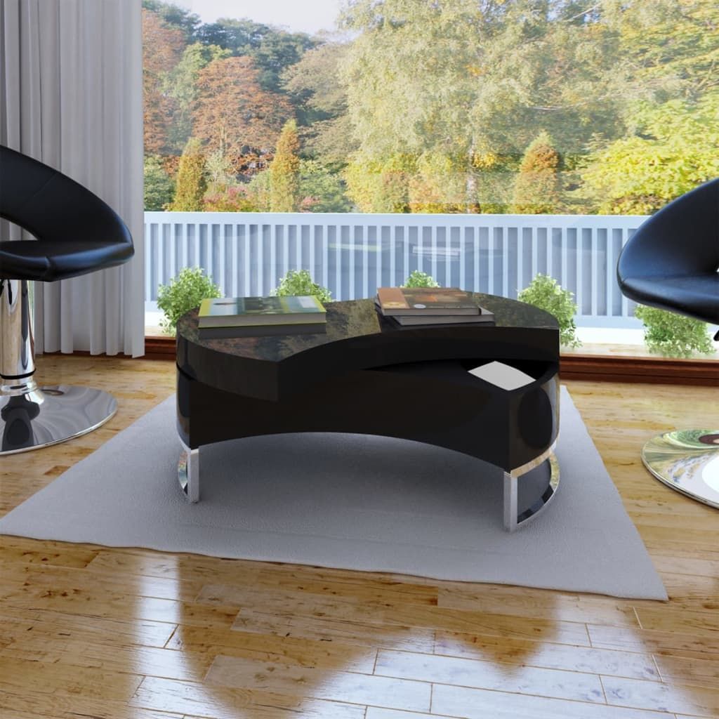 Coffee table in high-gloss black MDF with stainless steel curved legs, placed on a light rug between two black chairs.