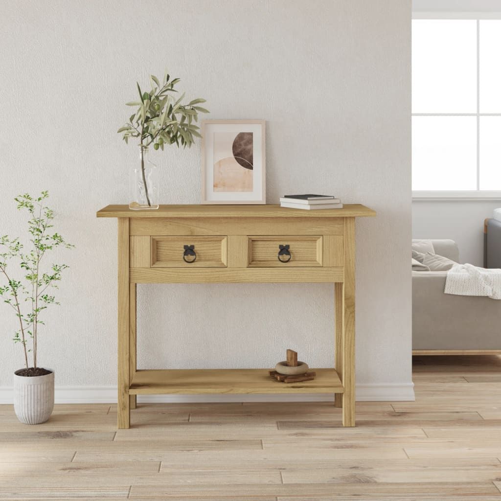 Console table in brown solid waxed pinewood with two drawers and ring-pull handles; vase with greenery and framed art.