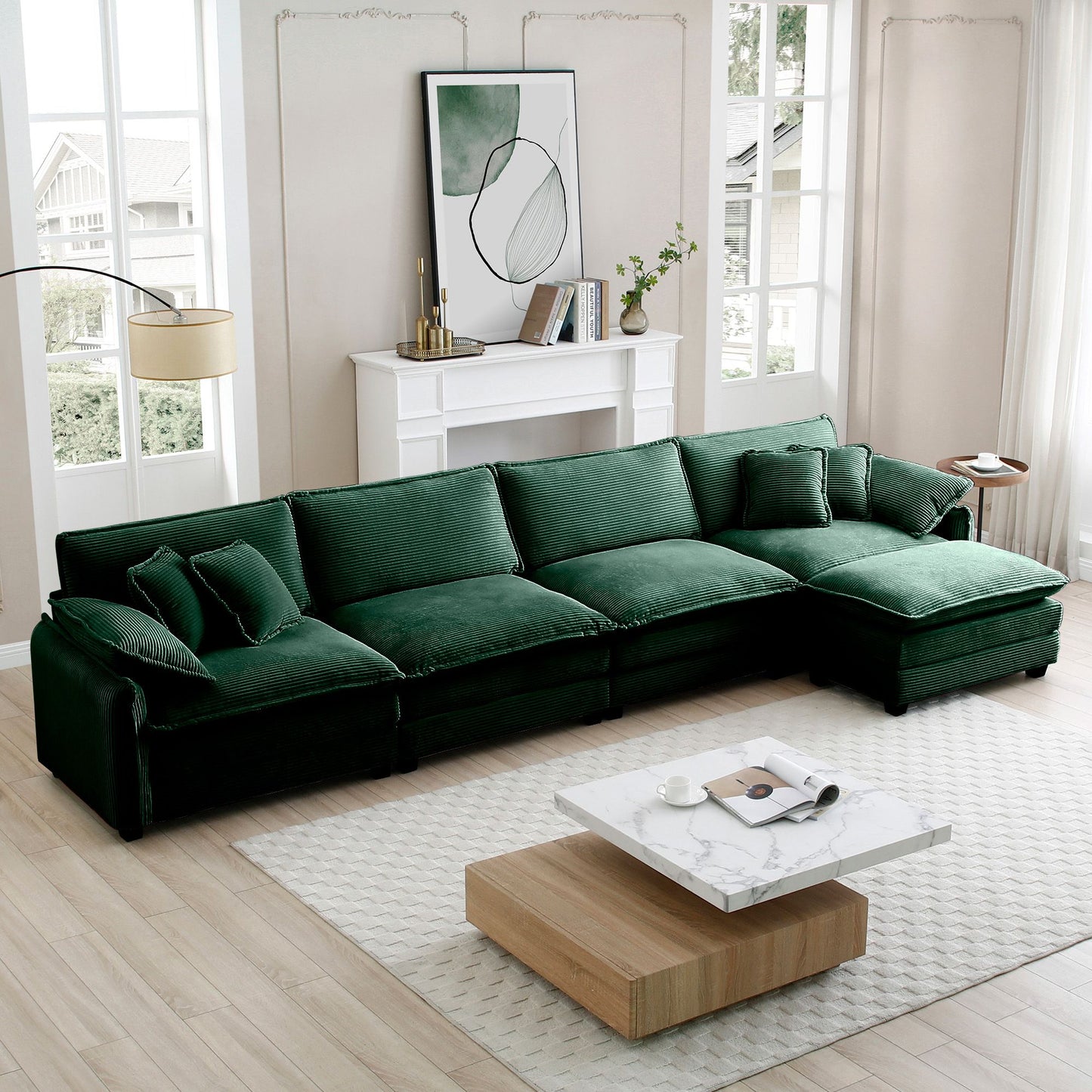 Corduroy 4-seat green sofa in a bright modern living room with white fireplace and abstract wall art