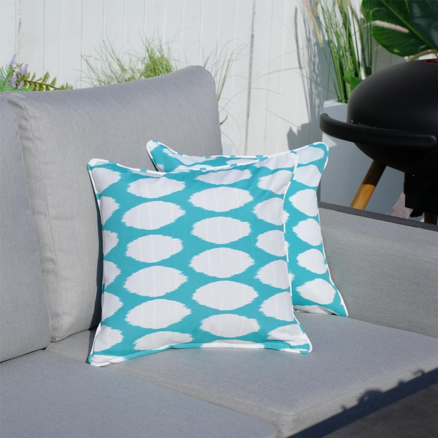 Throw pillow set, 16.54-in square, 2-pack, teal and white polka dot on gray outdoor couch by Doba
