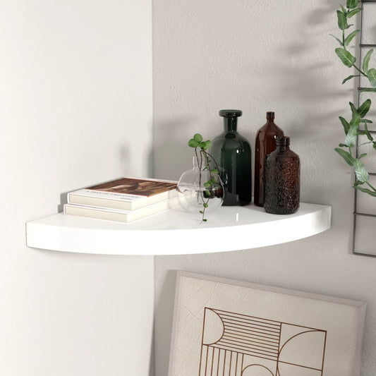 Corner shelf in high-gloss white, curved edge corner unit with two books, glass vase with plant, and brown/green bottles