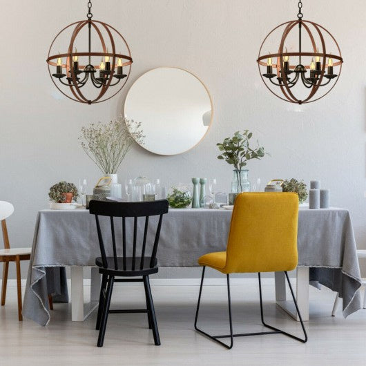 Two 6-light orb chandeliers with rustic bronze metal spheres and candle bulbs hang over a dining table.
