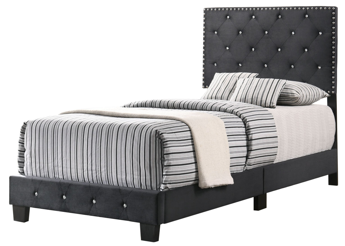 Twin bed with black tufted upholstered headboard, silver nailhead trim, and striped bedding