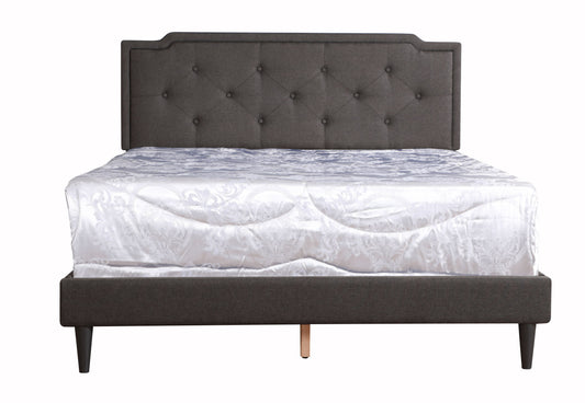 Sleek black upholstered bed with diamond-tufted headboard and white damask-patterned bedding