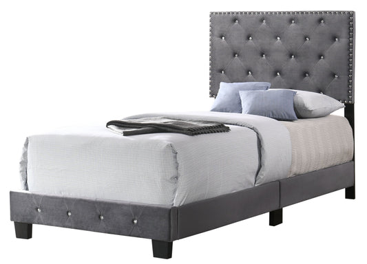 Twin bed with gray tufted upholstered headboard featuring diamond tufting and nailhead trim