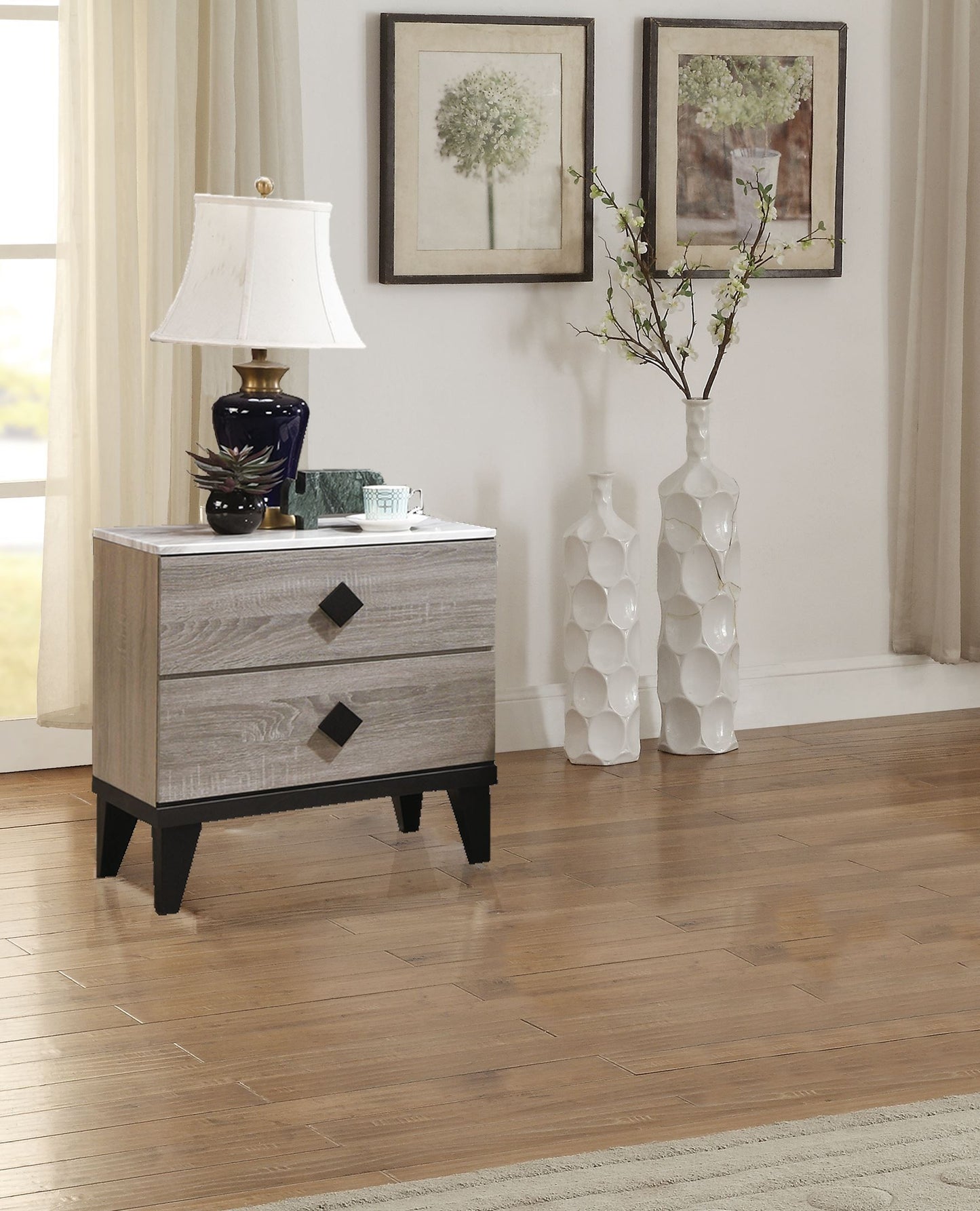 Nightstand in Cream Oak finish with black legs and three drawers.