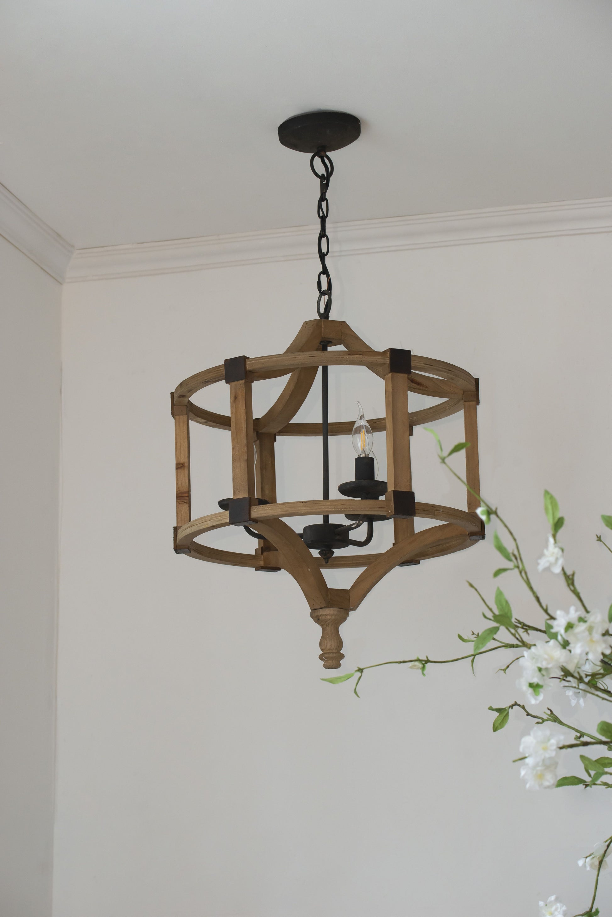 3-light wood drum chandelier hanging from an adjustable black chain