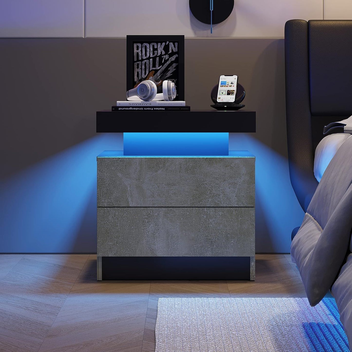 Nightstand with 2 drawers in gray concrete finish, blue LED underglow; headphones and smartphone on top (Doba)