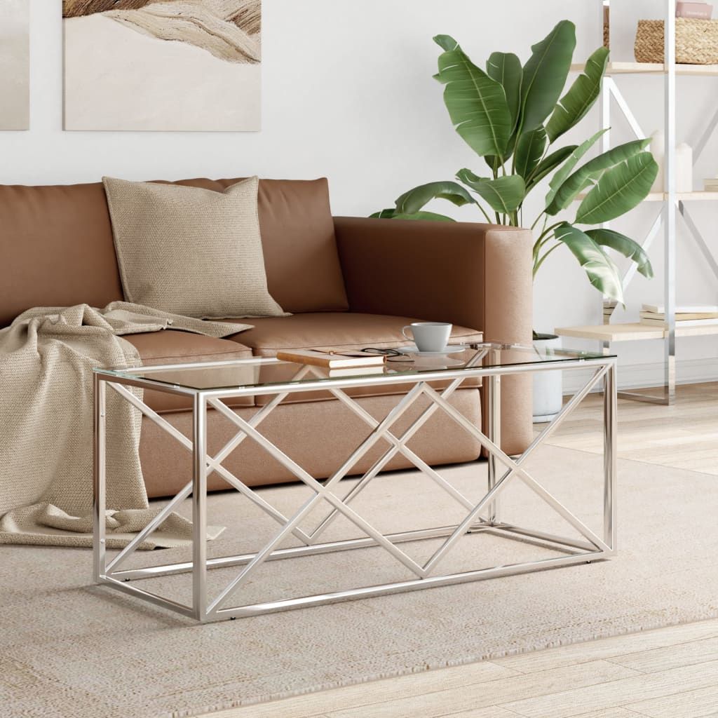 Coffee table with a silver stainless steel frame and tempered glass top in a modern living room